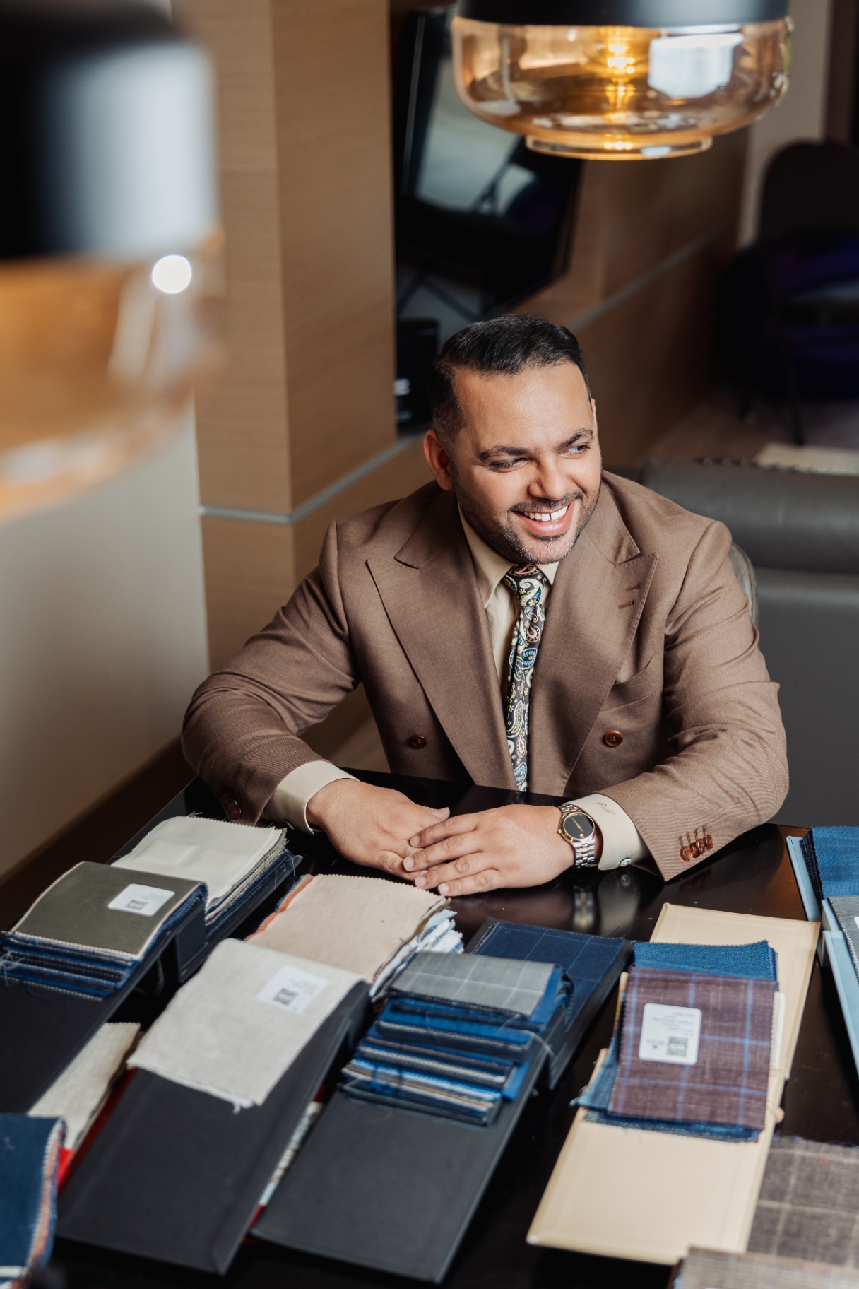 Rajat Nagpal laughing during a fabric consultation at Suited Booted & Co.