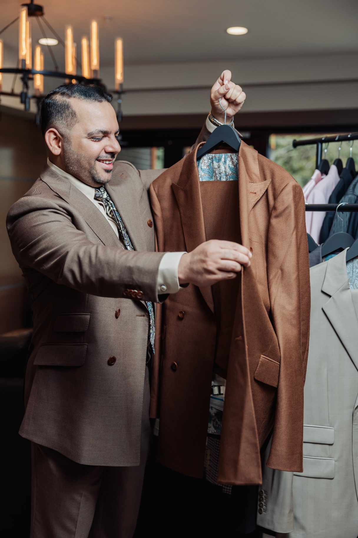 Rajat Nagpal presenting a hand-finished bespoke jacket with silk lining